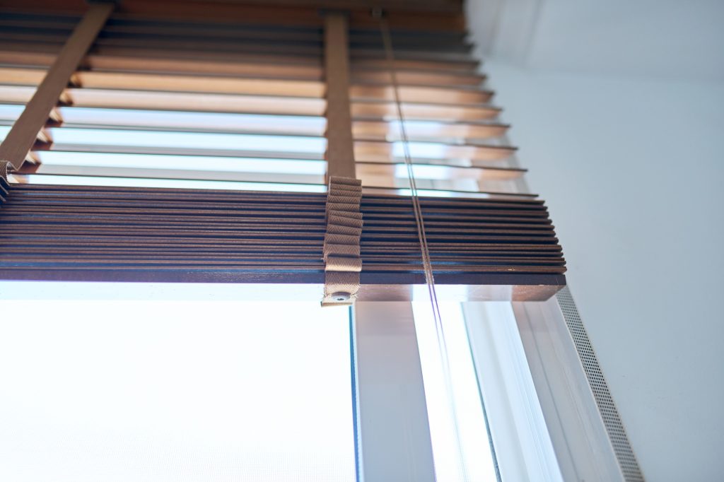 Brown wooden blinds in the interior close-up