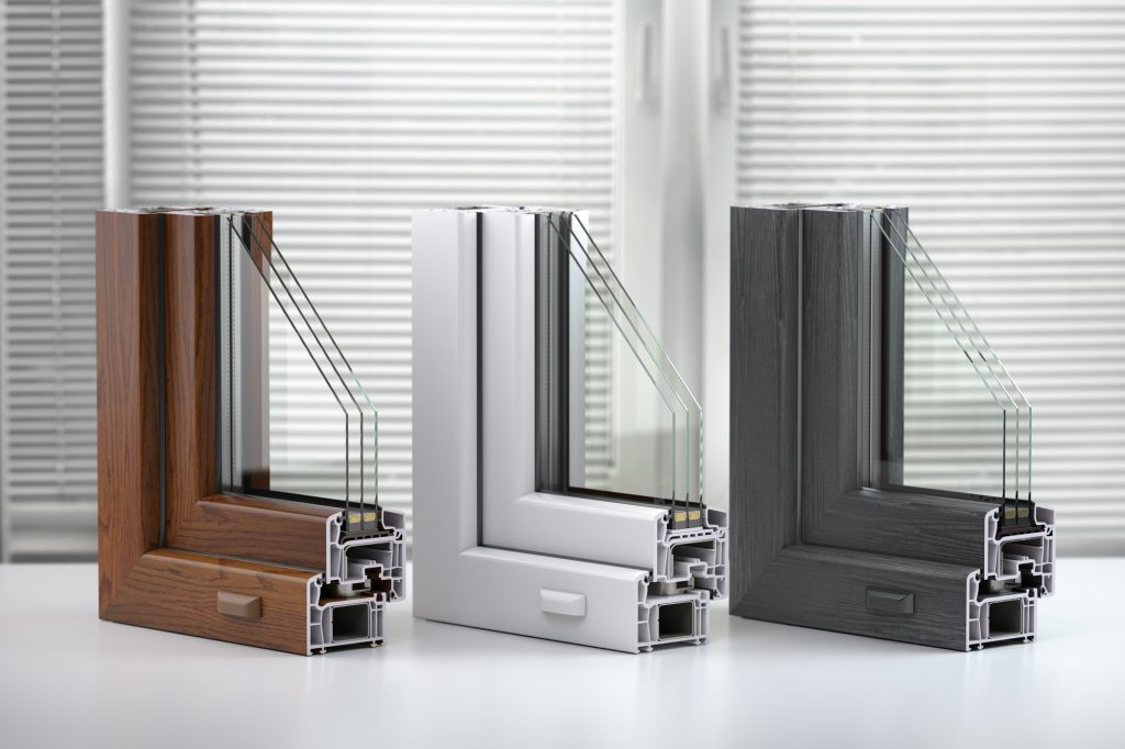 Plastic windows profile PVC of different colors in section on the table in office.